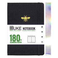Close-up of gold bee logo on black fabric notebook cover
