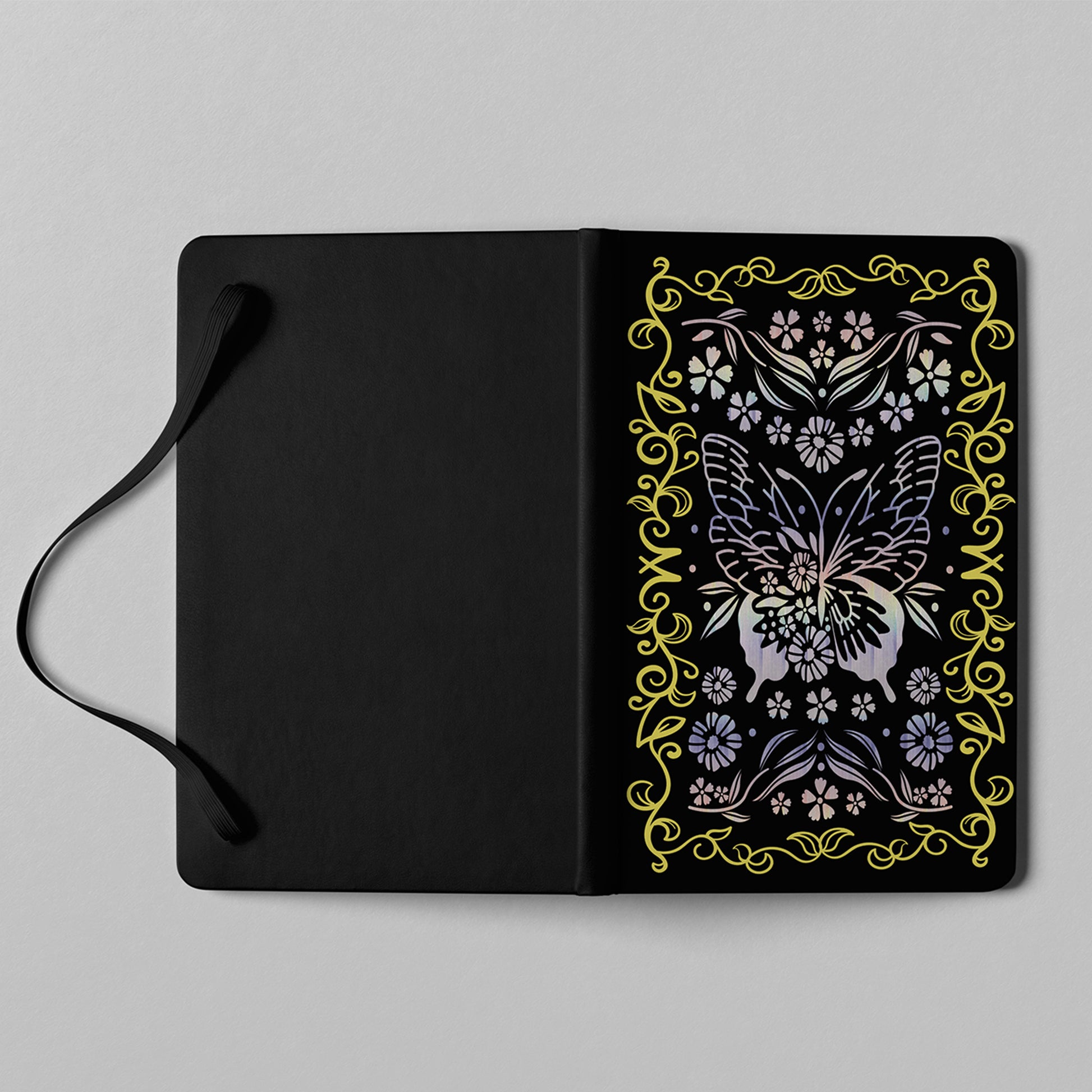 Close-up detail of holographic butterfly and floral cover artwork on notebook