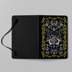 Close-up detail of holographic butterfly and floral cover artwork on notebook