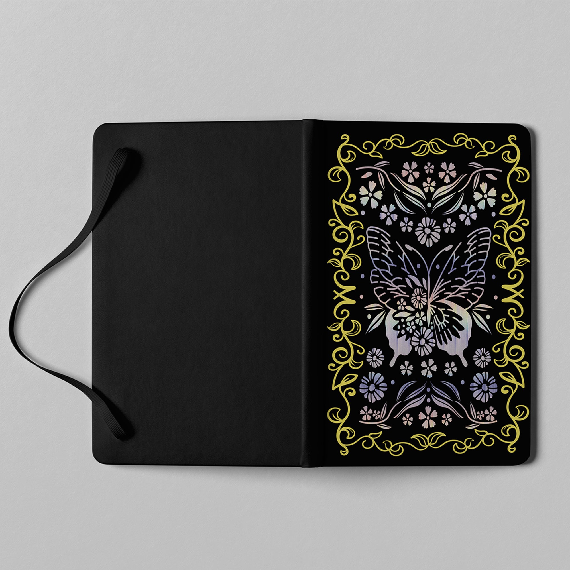 Close-up detail of holographic butterfly and floral cover artwork on notebook