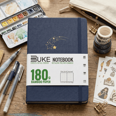 BUKE navy blue fabric dot grid notebook with gold shooting star logo