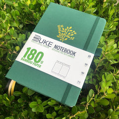 BUKE green fabric dot grid notebook with gold botanical logo